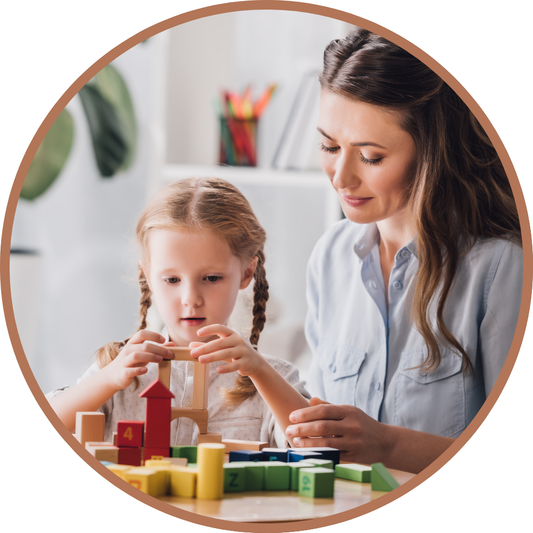 Girl engaged in educational activity with building blocks at a table.